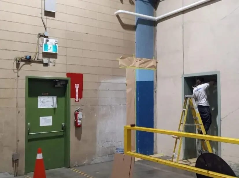 Industrial interior with coated structural surfaces and equipment