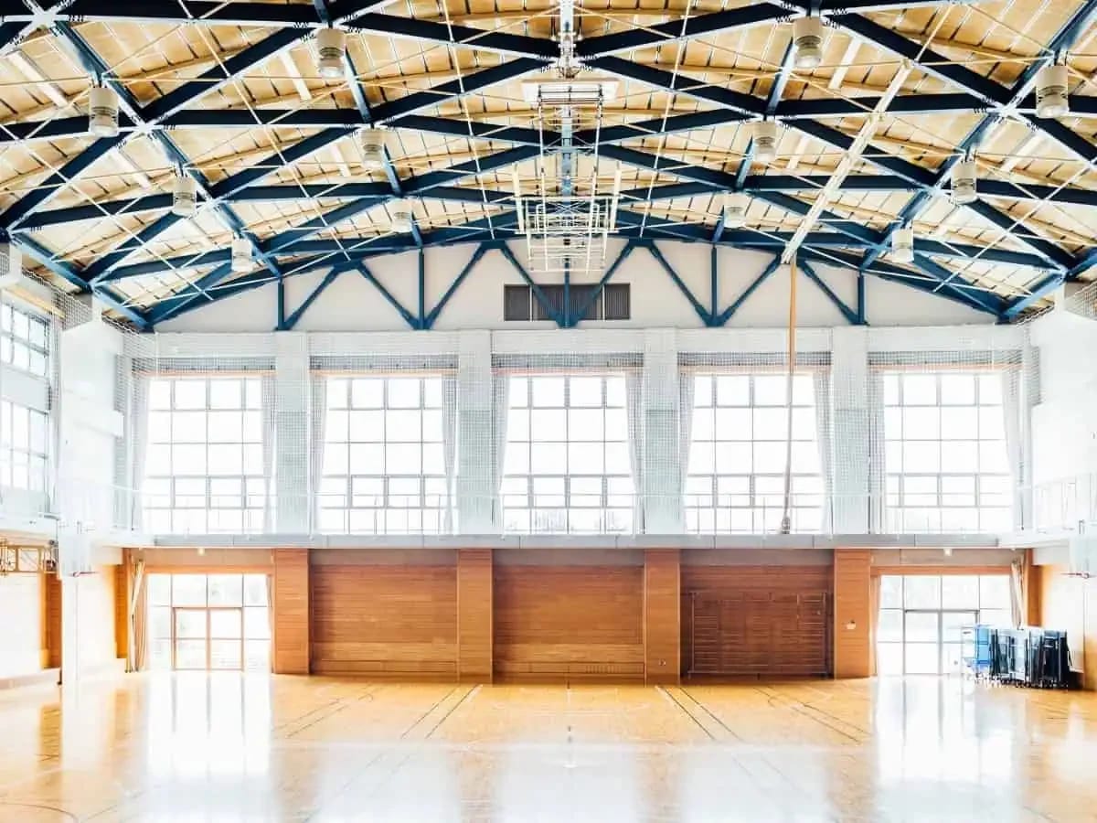 Bright indoor gymnasium with painted walls and ceiling